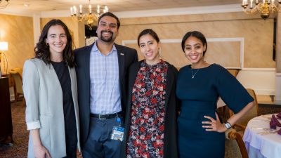 Four medical students standing in a row posing for picture