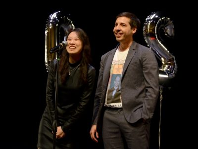 Oscar Alcoreza stands beside Jennifer Park behind a microphone as they announce their residencies.